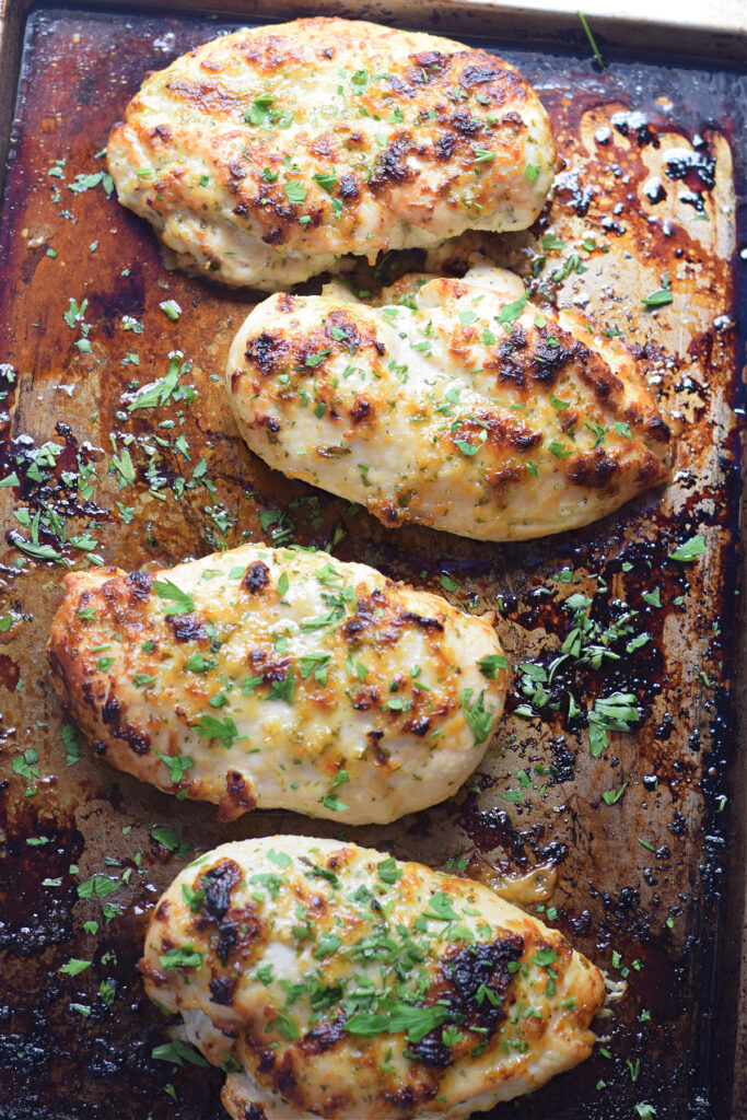 Baked chicken breast on a tray.