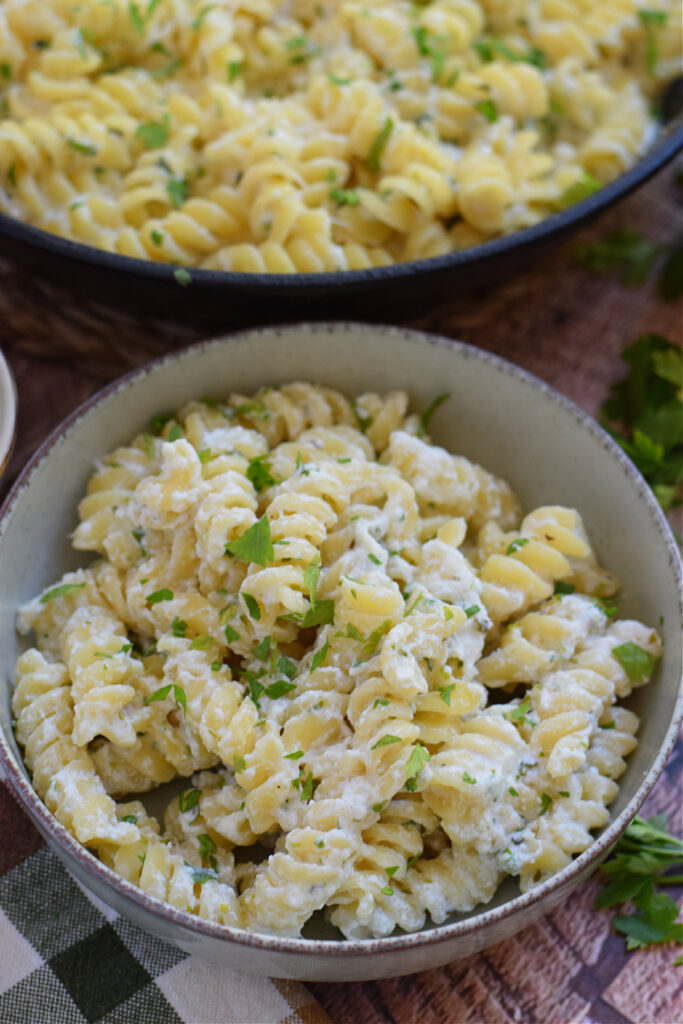 Spiral pasta in a white bowl.