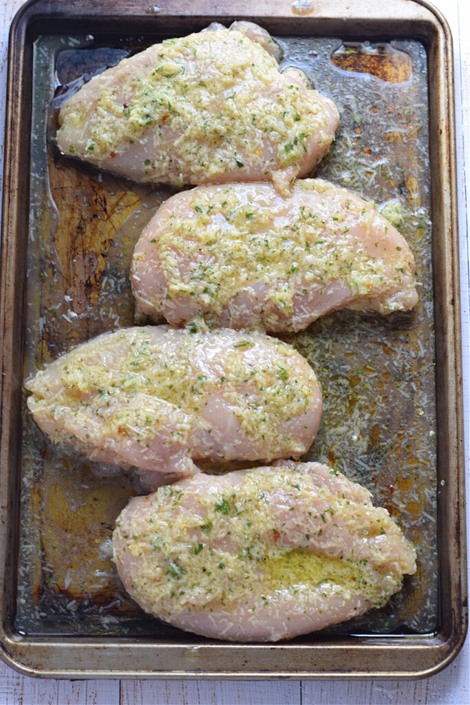 Chicken breast on a baking tray.
