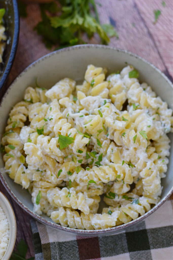 Close up of pasta in a small white bowl.
