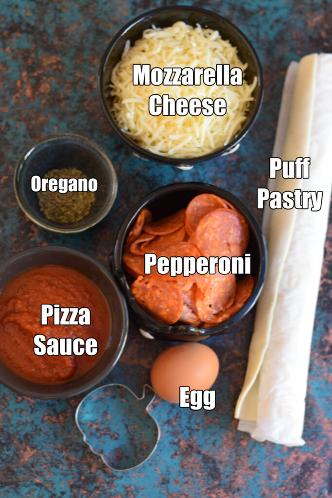 Ingredients to make halloween mini pizzas.