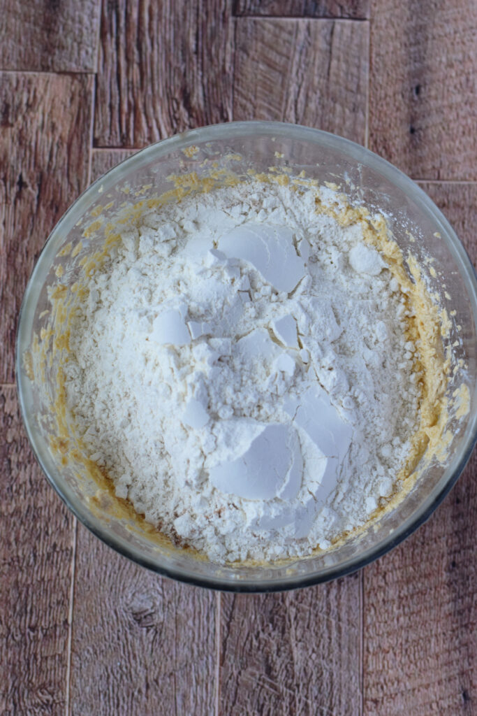 Adding flour to the cookie dough.