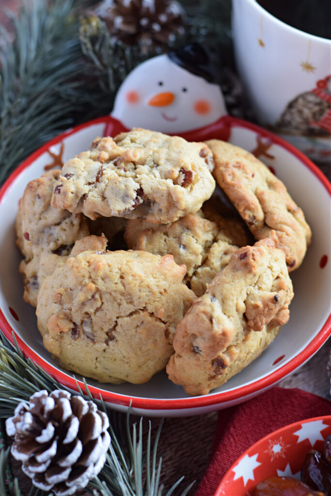 Date and pecan cookies in a christmas bowl.