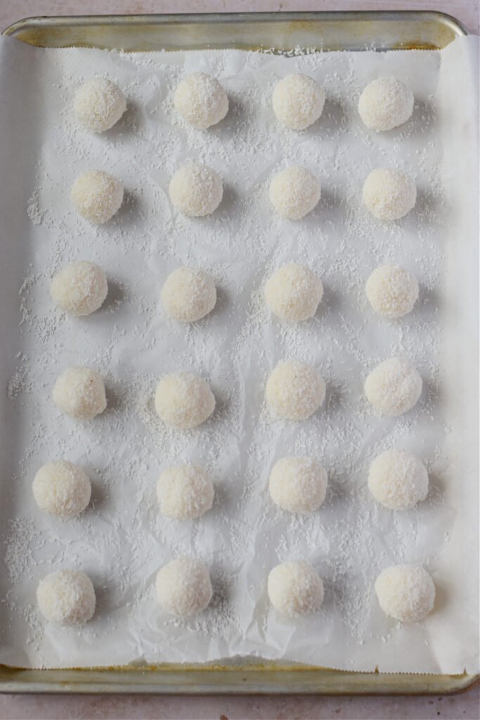 Coconut balls on a baking tray.