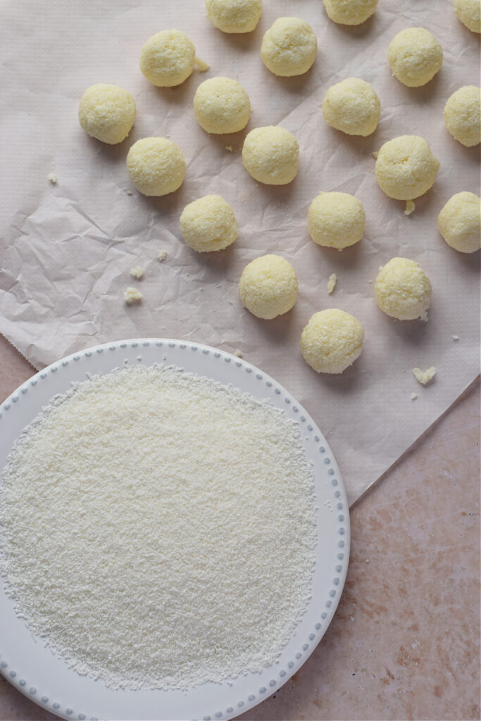 Coconut balls on parchment paper.