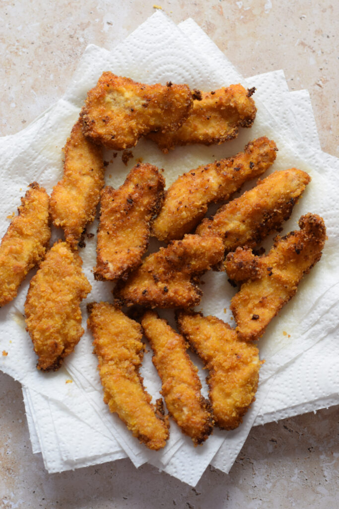 Chicken strips on paper towels.
