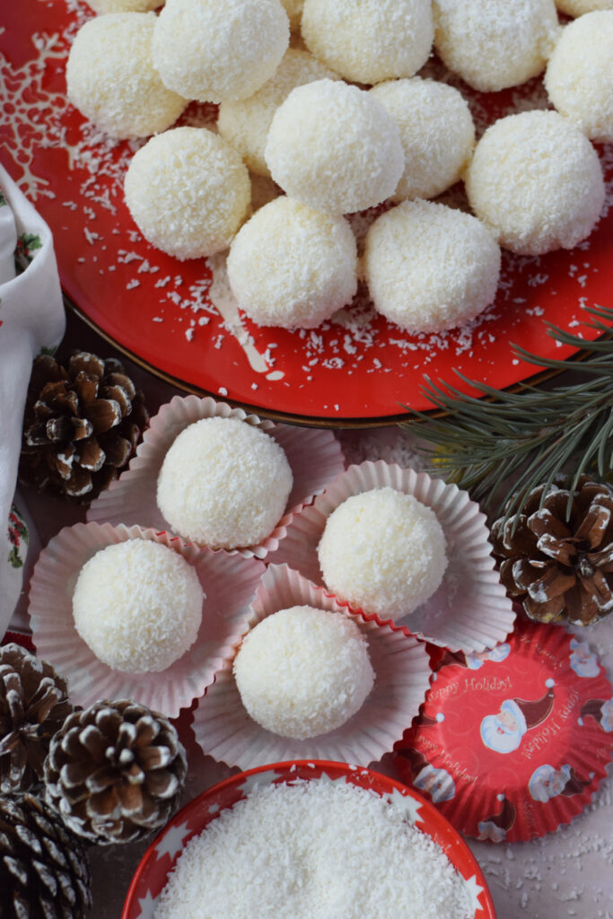 Coconut balls on a red plate.