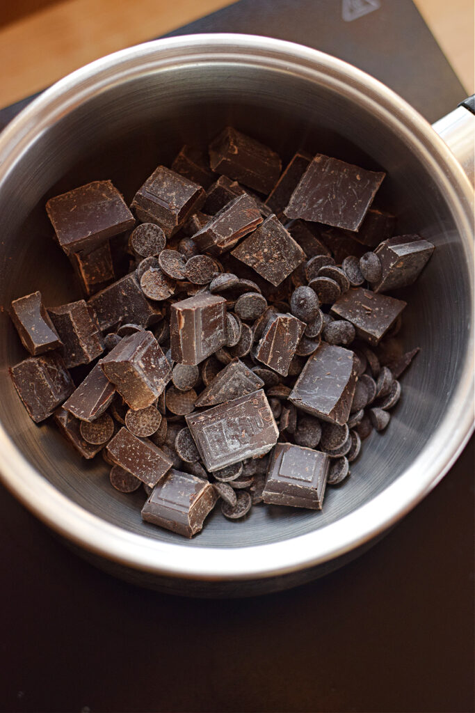 Chopped chocolate in a saucepan.