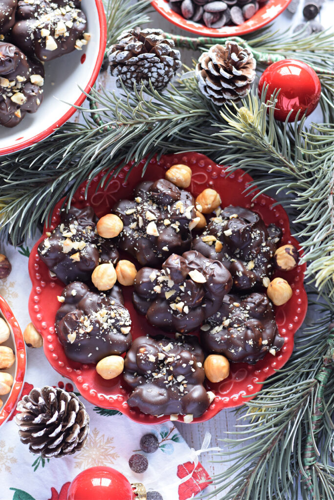 Chocolate hazelnut clusters on a red plate.