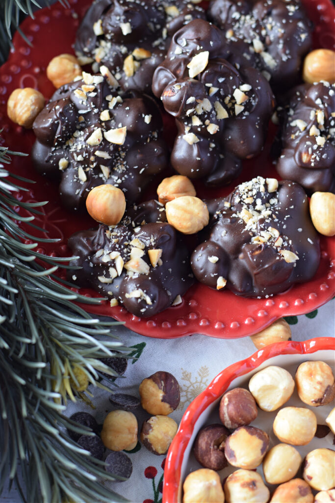 Chocolate hazelnut clusters on a red plate.