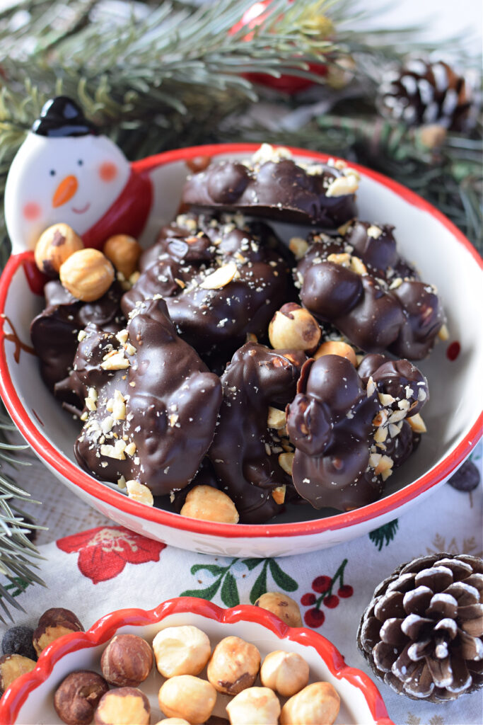 Chocolate and hazelnuts in a christmas bowl.
