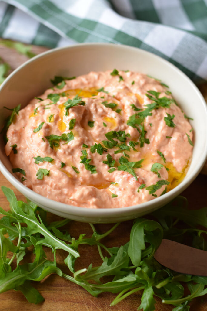 Roasted pepper dip in a white bowl.