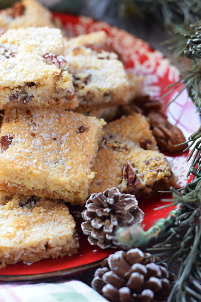 Coconut bars on a red plate.