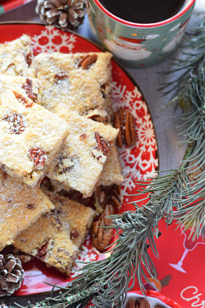 Cookie bars on a red christmas plate.