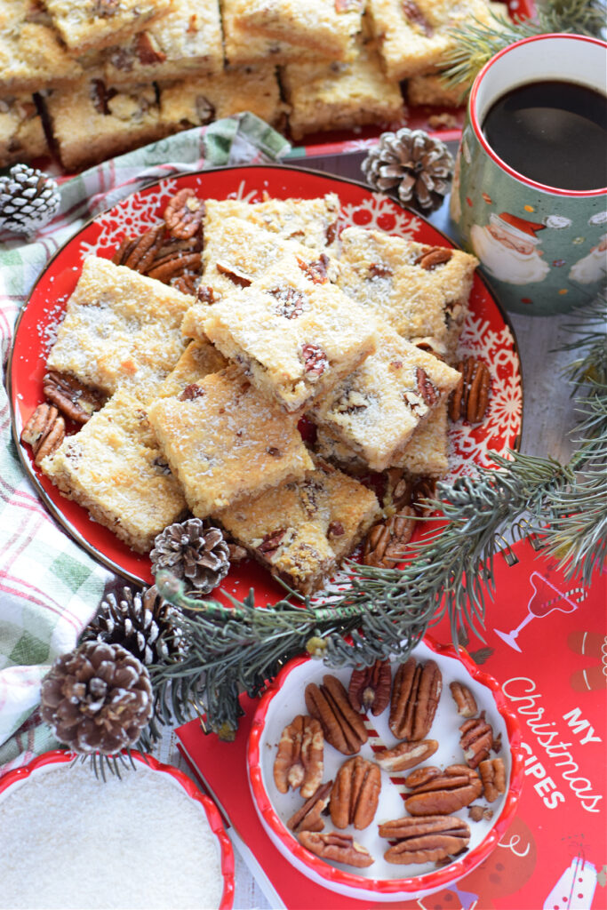 Coconut pecan cookie bars on a red plate.