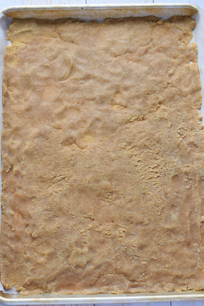 Cookie dough pressed into a cookie sheet.