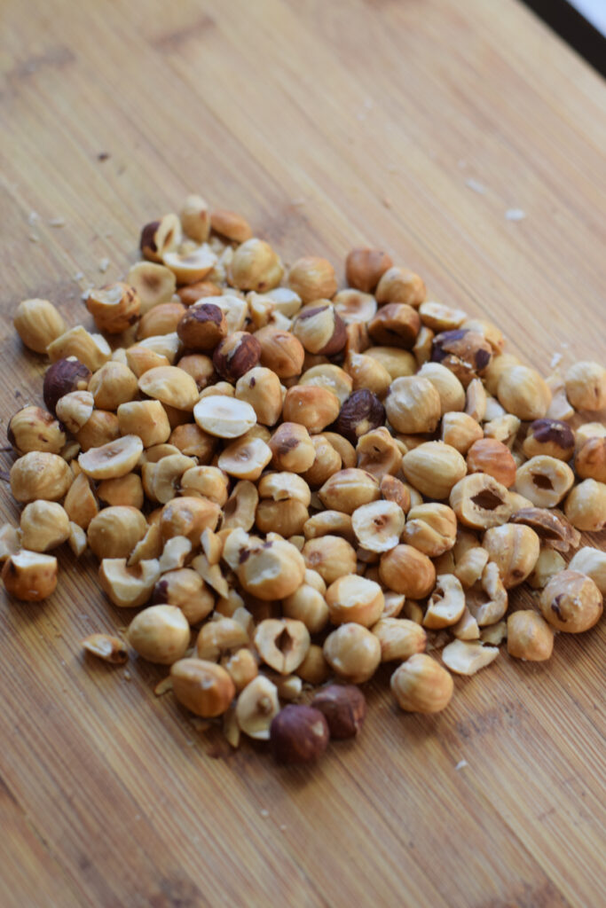 Chopped hazelnuts on a wooden board.