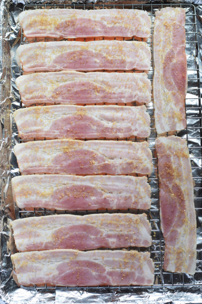 Ready to bake brown sugar bacon on a baking tray.