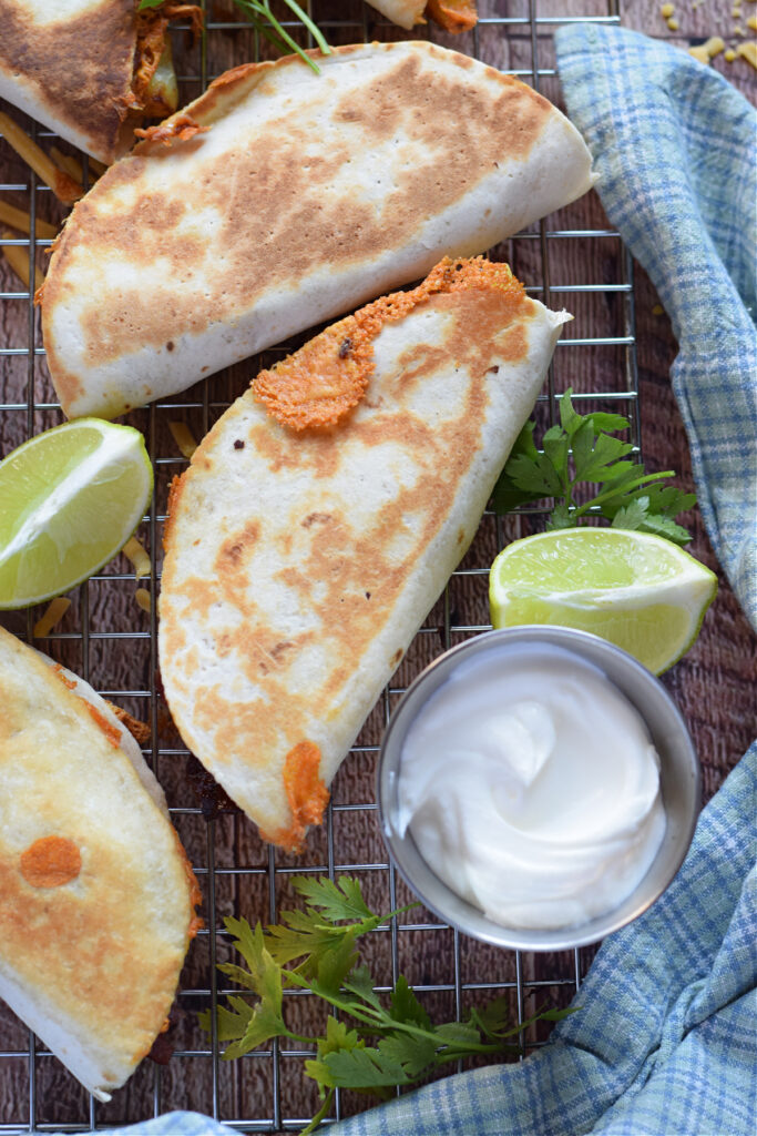 Breakfast tacos with lime wedges.