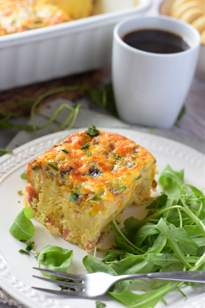 A piece of breakfast casserole on a white plate.