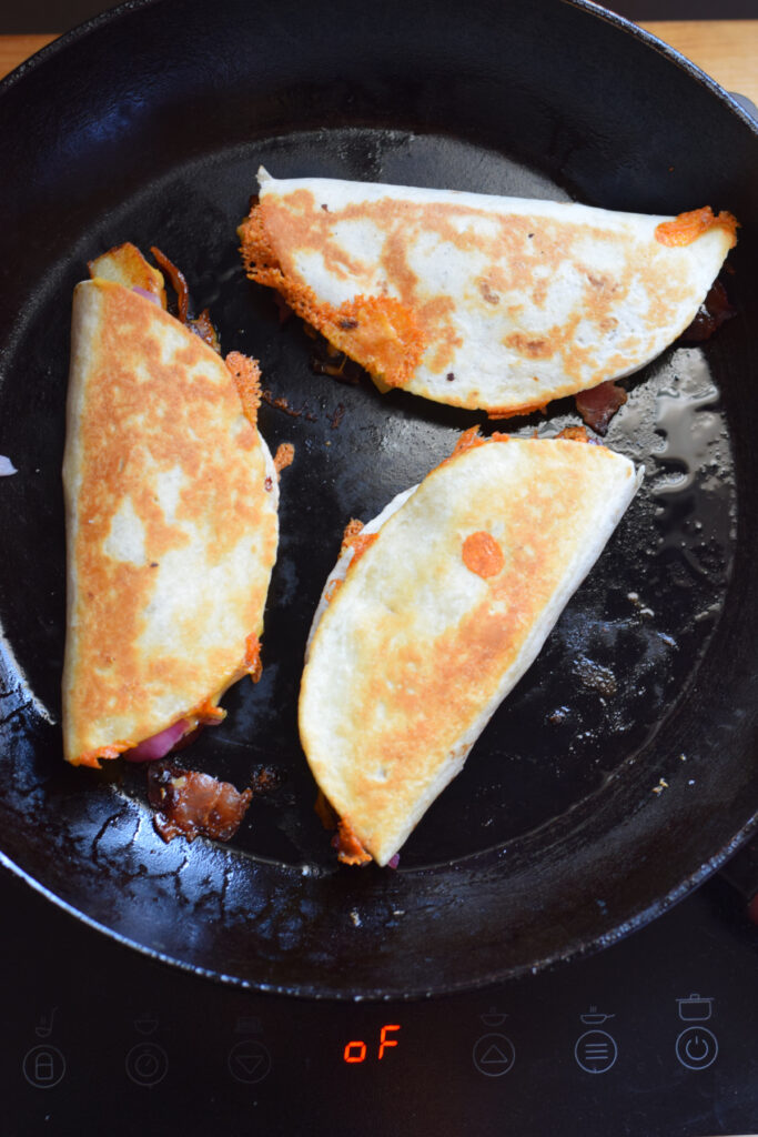 Cooking breakfast tacos in a skillet.