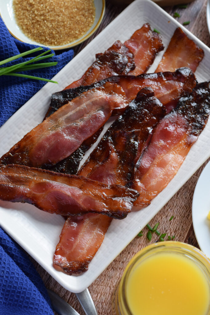 Close up of candied bacon on a white plate.