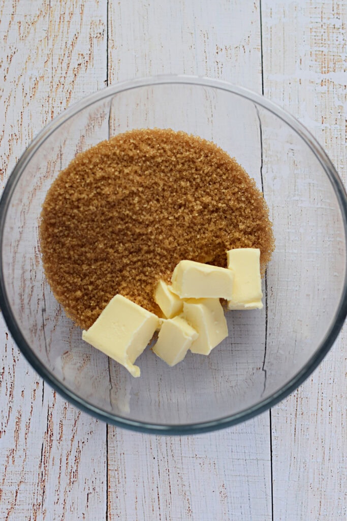 Brown sugar and butter in a glass bowl.