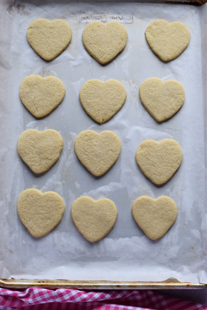Baked heart cookies on a baking tray.