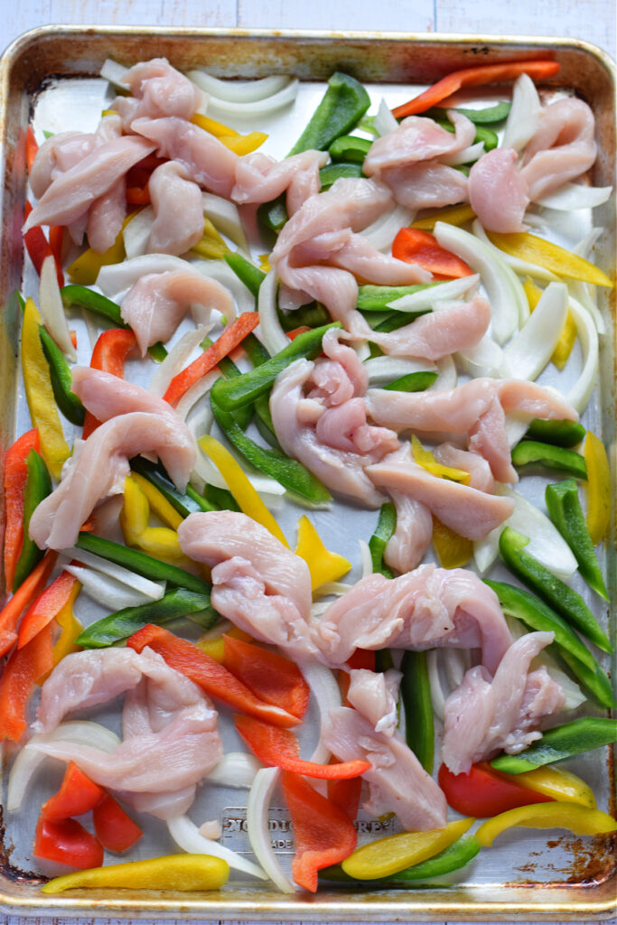 Chicken and peppers on a tray.