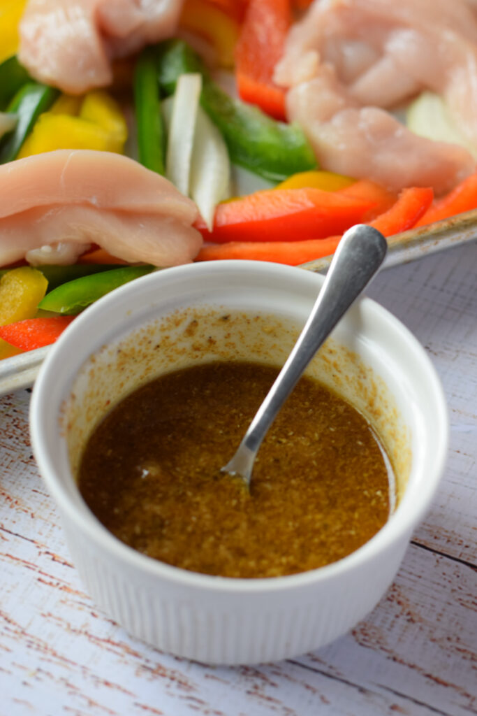 Chicken fajita marinade in a small white bowl.