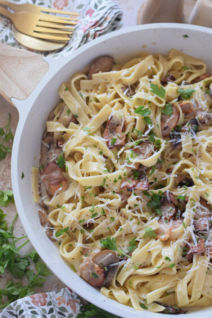 Close up of tagliatelle pasta in a skillet.
