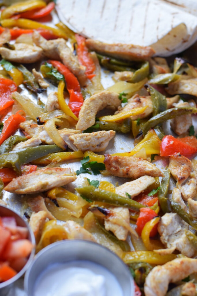 Close up of sheet pan chicken and peppers.