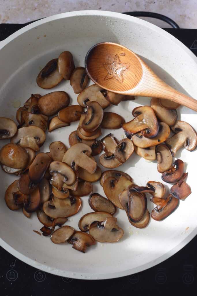 Cooking mushrooms in a skillet.