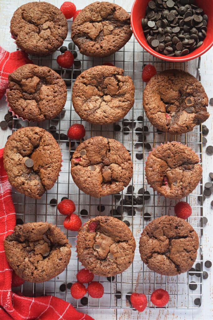 Baked raspberry chocolate muffins on a tray.