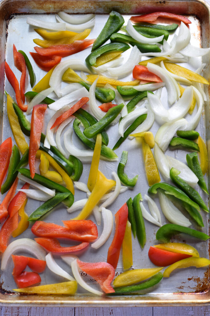 Peppers and onions on a baking tray.