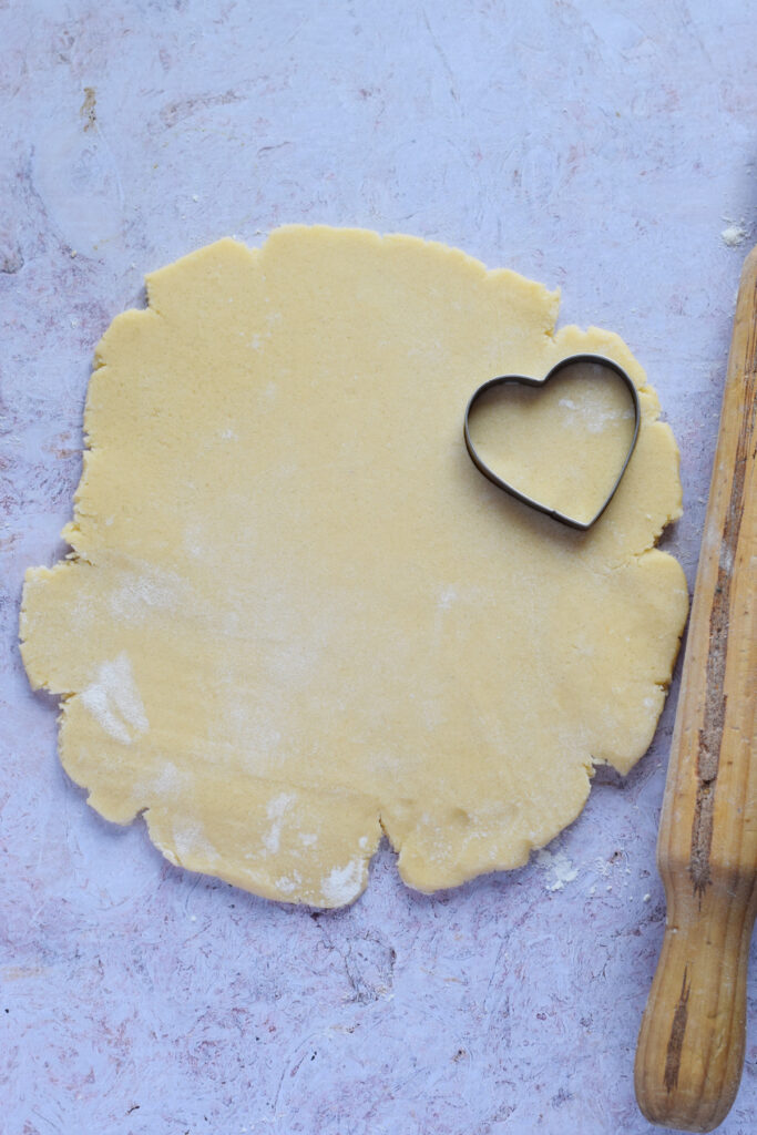Cutting out heart cookies.