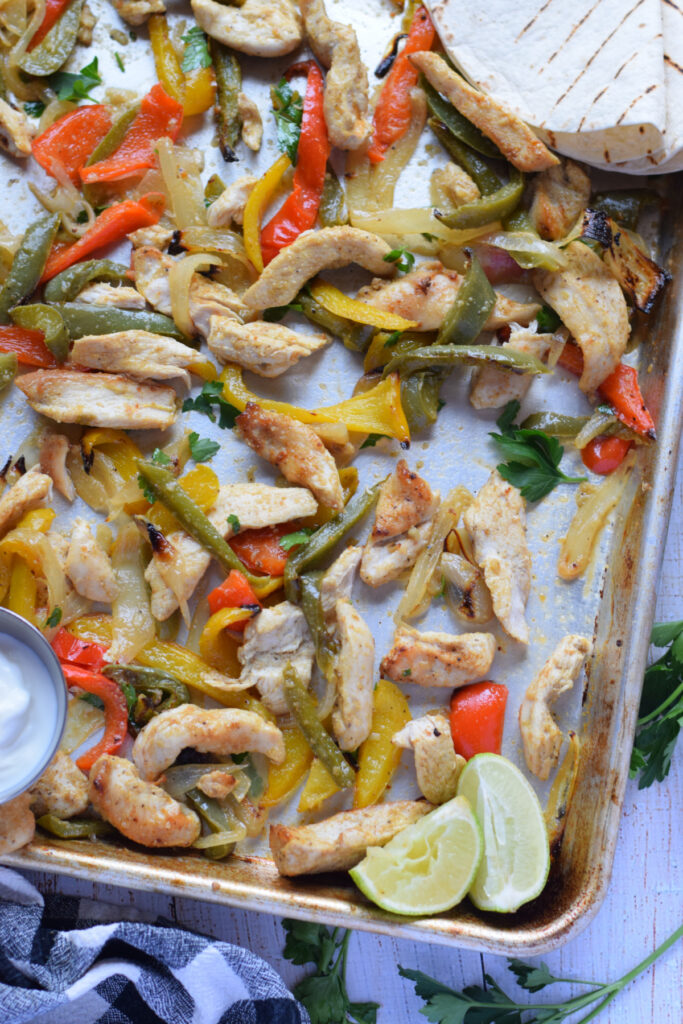 Sheet pan chicken and peppers on a tray.