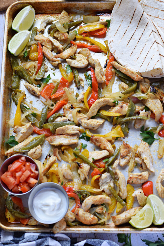 Sheet pan chicken and peppers on a tray.