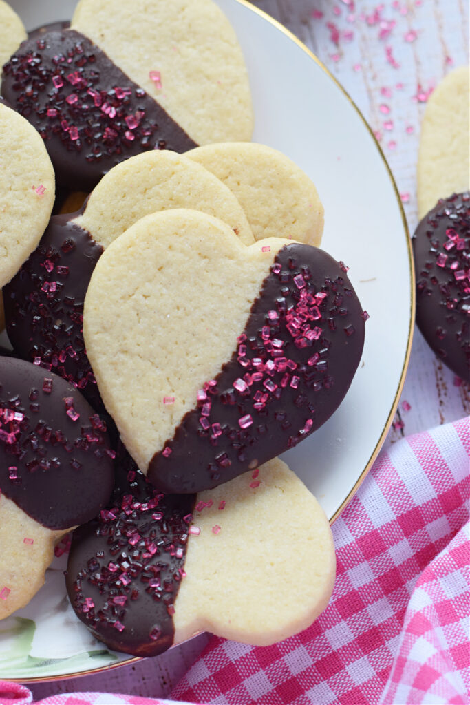 Chocolate heart cookies on a white plate.