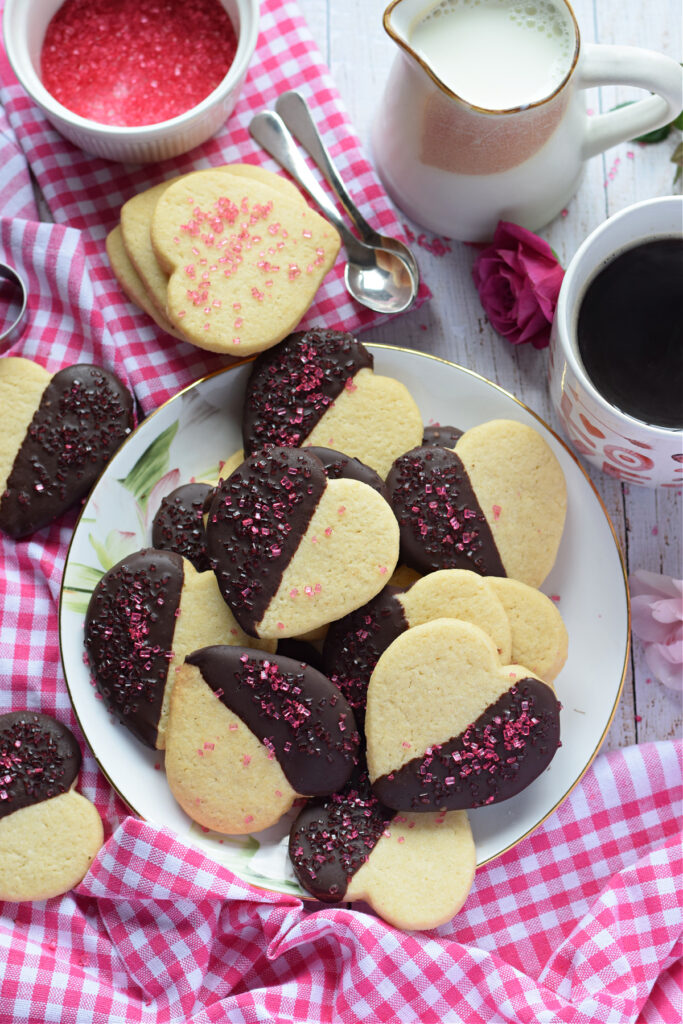 Chocolate dipped sugar cookies on a white plate.