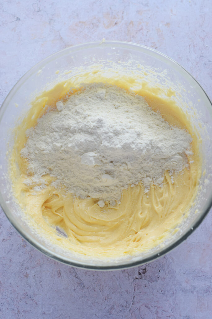 Adding flour to muffin batter.
