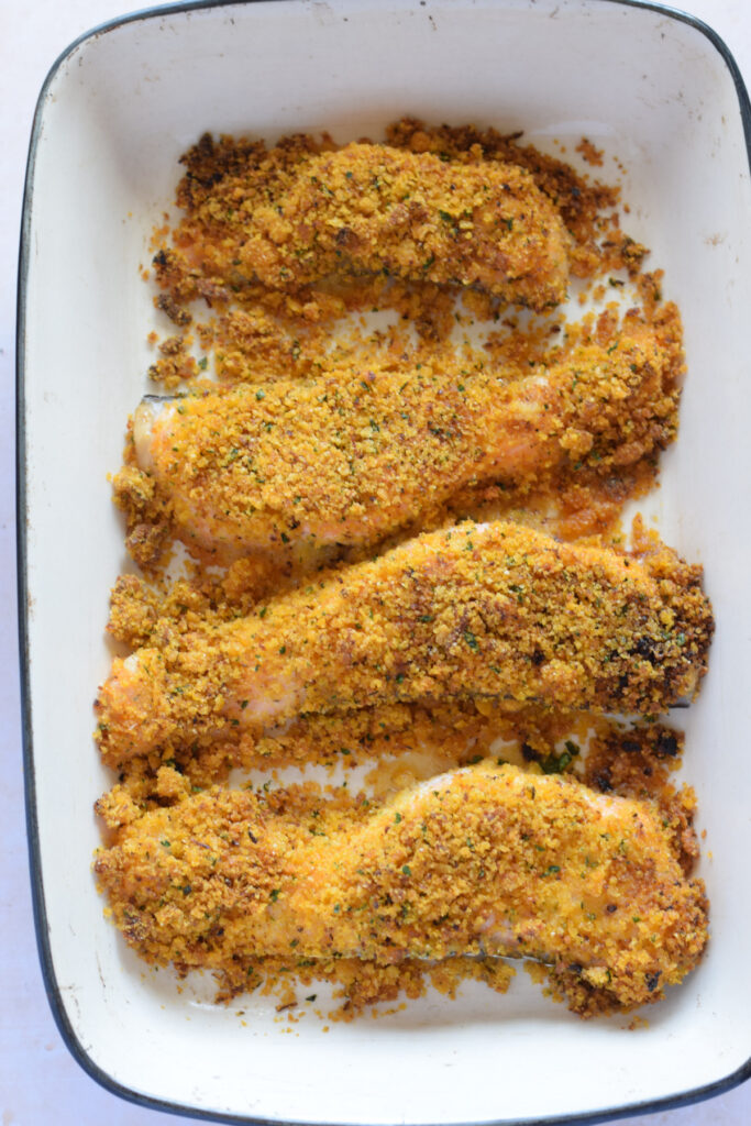 Panko crusted salmon in a white casserole dish.