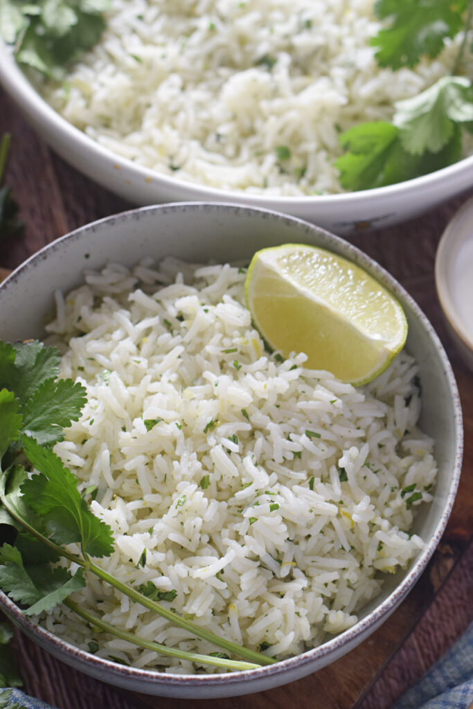 Close up of white rice in a bowl with lime.