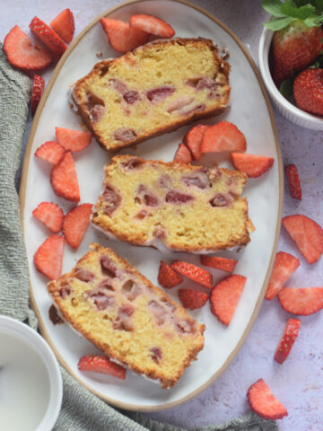 Slices of strawberry loaf cake on a white plate.