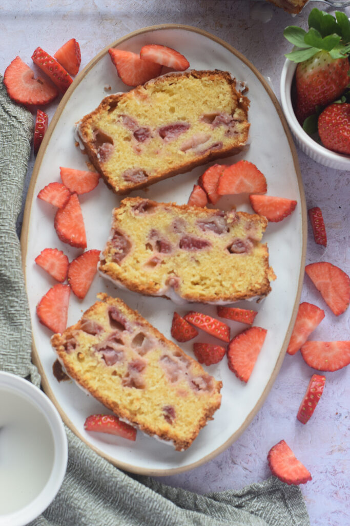 Slices of strawberry loaf cake on a white plate.