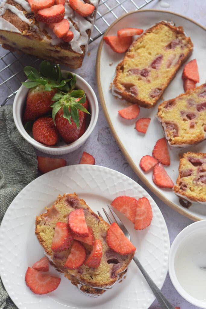 Slice of strawberry loaf cake on a white plate.