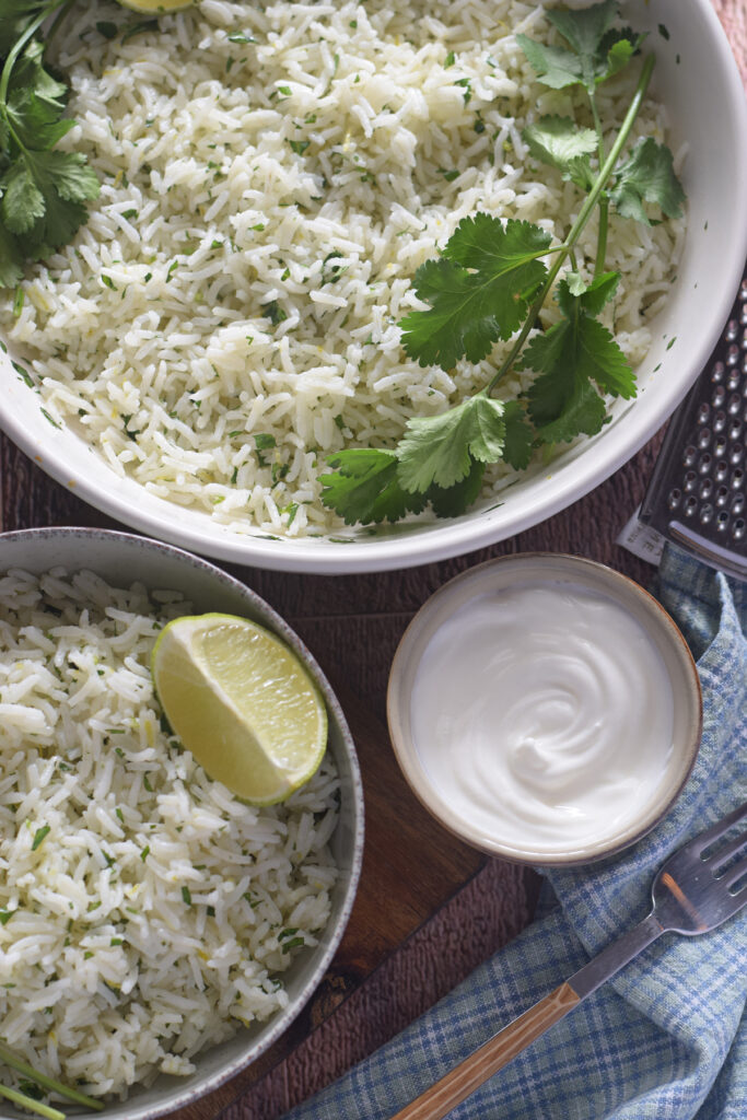 Basmati rice with lime and cilantro in white serving bowls.