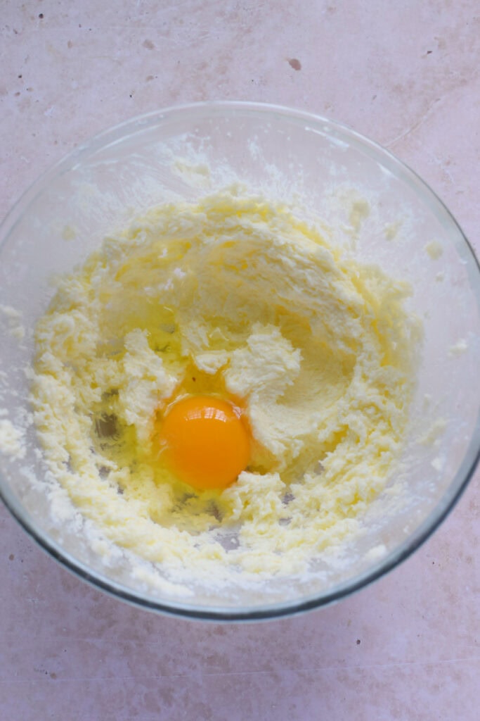 Adding eggs to cake batter.