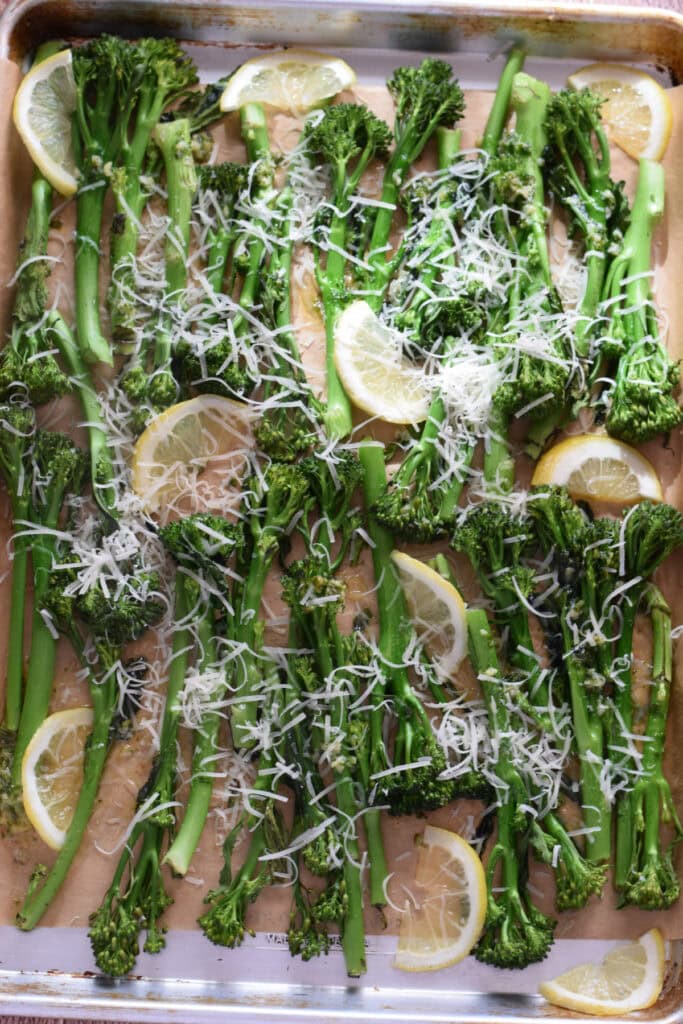 Broccolini with parmesan on a baking tray.