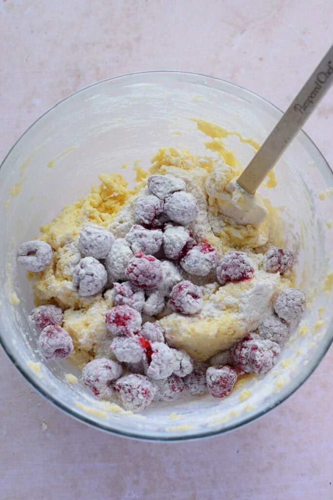 Folding raspberries in cake batter.
